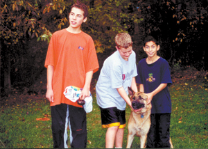 Meeting “new” friends and making memories at Camp Potawotami.  Pictured from right to left; Jesse Dominquez, “Freddie” (one of 4 dogs and 2 pot-bellied pigs kept at camp), Jordan Cornwell, and Alex Cornwell.