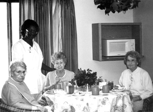 (photo from left to right) Maxine Brown, Barb Woodfin (Dietary Manager), Rita Martin, and Betty Cunningham not knowing each other prior to coming, have become friends and do many of the activities and outings together. Maxine states, “I have made some good friends, quite a lot of friends here at Riverbend. The nurses are nice, too.” Indeed it has become these ladies’ home and they, as well as the other people, are encouraged to bring items from home that will make their room special.  “I have brought my pictures, bedspread, and rocking chair to make my room like home. I have always crocheted and I’m working on a bedspread right now,” commented Betty. Some things may be different than at home, though. As Rita stated, “ I really enjoy the food, especially since I do not have to cook or wash the dishes.”