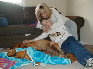 Betsy, Justin and Buddy with her pups