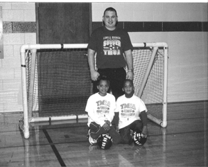 Learning the rules and skills of soccer is 7 year old Soccer League Player Angelique Wilson,  and Tiny Tot Indoor League Player Daniel Wilson, 5 years old with Program Director, Neil Condon.