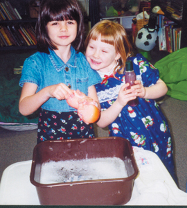 (l-r) Ashley and Katie bathing babies from the 4 and 5-year olds.