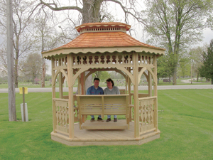 Expanding living to the outdoors…Steve and Gayla Gerber enjoying one of the many Amish-Crafted Gazebos. Steve’s Landscaping also carries porch swings, playsets and planters.