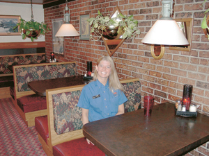 New manager Carri takes a break in their newly remodeled Pizza Hut dining area.