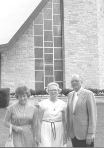 (L to R) Lois Oetting, Alma and Harold Hollman in front of church windows designed by Harold’s business, City Glass Specialty (church is in Grafton, WI).