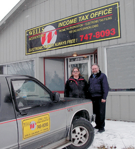 Connie Wells and her husband Al in front of their new accounting business in Waynedale at 2505 Lower Huntington Road.  Al owns Wells Auctioneering and drives bus for PTC.  Connie employs eight people during tax season and hopes to continue to grow her business to other areas of town. 