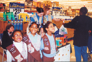 Brownie Girl Scout Troop #558 (Irwin Elem) (l-r) Sarah Roberts, Shakyra Robinson, and Korina Roberts learn business savvy during cookie sales at Kmart South from Cadette Girl Scout Troop #891 (Lake & Coliseum) Erin Lorenzen and Dana Leinhos.