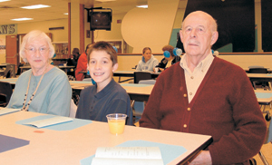 Miami Middle School student Manny Colburn enjoys breakfast with his grandparents Bill and Anna.