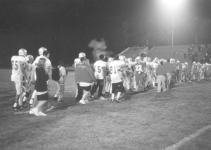 photo by rls #22 Jared Richards leads the Wayne Generals in congratulating the Elmhurst High School Trojans on their second win of the season. Elmhurst won the game 31 - 13 on Friday, September 13, 2003.
