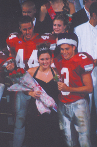photo by Alex Cornwell Homecoming Queen, Heather Guerrero and King, #3 Cole Hale celebrate their new reigns during half-time ceremonies on the September 17, EHS football game. #44 Matt Lindelien and court member Abby Resor follow in the procession.