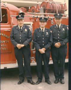 (l-r) Captain James Mason, Delmar Green, and Kenneth McCague pose in front of pumper truck that carried over 1400 gallons of water. Below-right is the tanker truck built by James Mason and volunteers.