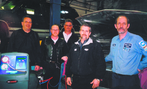 Roppel representatives, Brian Densford, Dennis Husband, Steve Yankowy and John Adams, work with owner Rich Elzey of Rich’s Auto Center on Thursday, March 10, 2005.