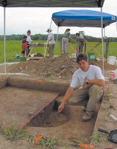 Assistant Director, Andrew White, IPFW Archaeological Survey, directs the excavation of sediments around an ancient fire pit. The Survey is committed to the dissemination of archaeological information and public involvement in Midwestern archaeology. They assist museums, local historical societies, and other groups in the investigation, documentation and interpretation of cultural resources. 