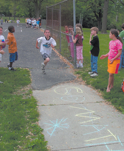 Conner Uffelman finishes the 5th and final lap around the playground at Waynedale Elementary School on Wednesday, May 18, 2005.