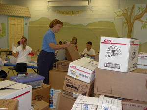  Canterbury School String Instructor Mrs. Lenelle Morse labels and organizes the many boxes of supplies ready for delivery to New Orleans hurricane devasted families now living in Baton Rouge, LA.