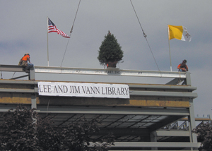  The “Topping Off Ceremony” included raising the tallest beam, complete with flags and a tree, on the Lee and Jim Vann Library and a speech by Jim Vann (right).