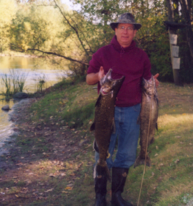 Tim Madru pulls these two king salmon out of the Muskegon River on Saturday, October 8, 2005.