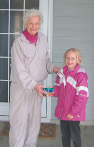 Brownie Girl Scout Ethel Troop 720 delivers nut order to Mrs. Elena Spuller.