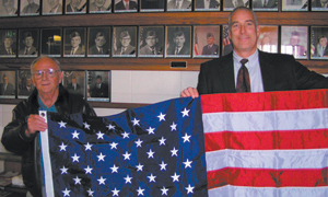 FW Vet-Carl Biesiada, left, is pictured receiving his flag from Steve Habig,  MarkleBank Vice President. 