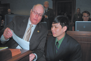 Sen. Thomas Wyss (left) goes over a piece of legislation with intern Steven Truong of Fort Wayne.
