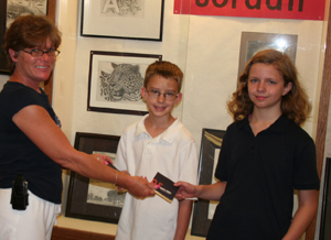 Terri Shimp awards reading awards to top Waynedale Elementary School readers, Jacob Crozier and Sara Livengood.