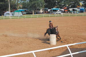 Katie Stark and Don Quixote round the second barrel in the barrel race.