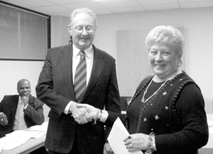 NEW BOARD MEMBER Attorney Bruce Stier is congratulated by Fort Wayne City Clerk Sandy Kennedy after she administered to him the Oath of Office as a Wayne Township Board member. The ceremony took place in December at the Wayne Township office after Mr. Stier was chosen to fill the Board position vacated by Maria Parra. Wayne Township Trustee Richard Stevenson, shown in background, was one of several persons who welcomed Mr. Stier to his new position. 