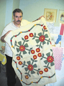 Marvin holds a hand- appliqué top circa 1850-1875.