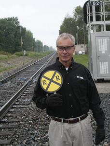 Operation Lifesaver Presenter, Doug Wylie at the railroad crossing on Lower Huntington Road in Waynedale.