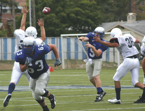 Quarterback Shaine Tierney throws a pass during scrimmage against Trine University, Tuesday, August 24, 2010. The next game will be Head Coach Kevin Donley’s 350th of his college coaching career. He’s won 236!