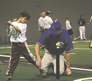 Seven year-old Eli Neimeyer picked up some tips from one of the IPFW baseball players during the Eric Wedge Baseball Clinic on Saturday, February 3 at the ASH Centre.