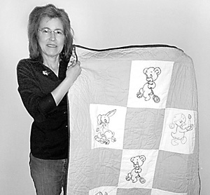 Kathy Wilson with her Christmas elephant quilt.