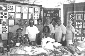Members of the Sisters of the Cloth Guild are all smiles at their quilt display at the Folklife Festival in Washington DC.