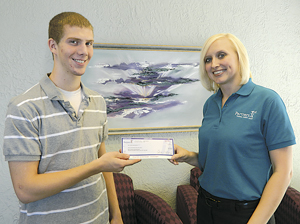 Matthew Anderson accepts scholarship check from Heather Bontempo, Branch Sales Manager – Partners 1st Time Corners office.