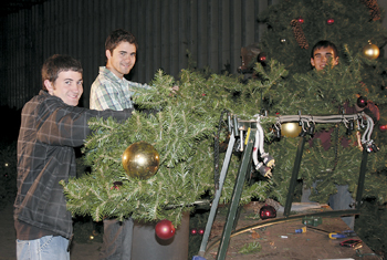 Abundant Life Church Volunteers Adam Miller and Robert Bontrader, along with Keith Fearnow of Jefferson Pointe Shopping Center begin to brighten the holiday season by replacing bulbs in preparation for the Jefferson Pointe Tree Lighting Ceremony.