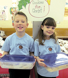 First graders Parker Schimmele and Addeson Steffen put on a big smile as they brought in their cookies to sell at the annual “Cookies for Christ” sale.