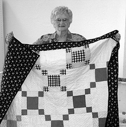 Joanne Sauder and the Ugly-pretty quilt set to be auctioned to benefit others.