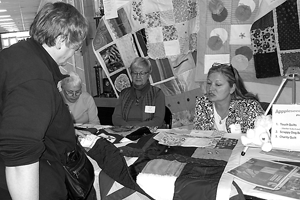 Jean Johnson of Hoosier Favorite Quilts, New Haven, learns about the Touch Quilt project from Appleseed Quilt Guild members Kathy Bogert, Shirley Pratt and Project Chair Beth Rajcany.
