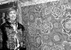 Long-time Harlan resident Shirley Spindler and her “Chintz” quilt made of Kaffe Fassett fabrics.