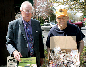 Jim Springer (L) and Lynn Henschen (R) of the Waynedale Lions Club proudly display thier recently collected 608 pairs of eyeglasses.