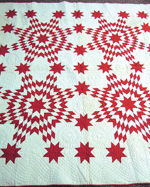 This dated and signed four square red and white star quilt with alternating feather wreath blocks is a fine example of late 1800 needle work.