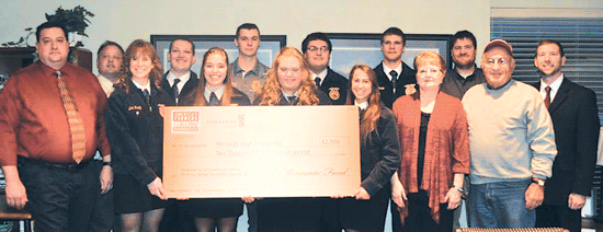 Winning farmers Ed and Edna Castleman and Monsanto Representative: AgriGold Joe Stephan present Heritage High School FFA with a donation of $2,500 from America’s Farmers Grow Communities, which is sponsored by the Monsanto Fund.
