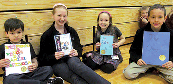 Saint Elizabeth Ann Seton Catholic School students holding the books that they wrote for the Young Authors program.