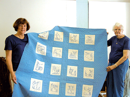 Granddaughter Janet Ramsey and daughter Rosemary Berry with Berenice (Gross) Bonar’s Biblical quilt.