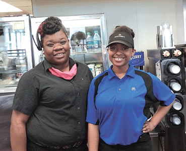 Charisse Jackson and Erika Bailey exchanging free food for acts of kindness at McDonald’s in Waynedale.