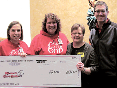 (L-R) St. Elizabeth Ann Seton First grade teachers Jessica Patton and Julie Peters, Anne Koehl of the Women’s Care Center, and Assistant Principal Greg Slee with check donation from making and selling cookies.