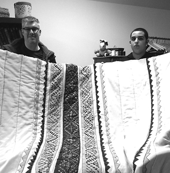Joe Salem and his son Eli were delighted when they picked up their newly restored Jordanian quilt.