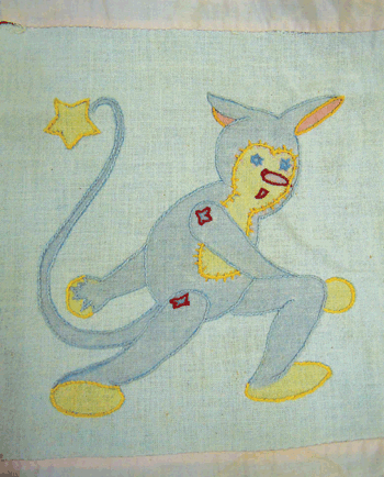 A boy in a mouse costume is one of the many charming blocks found on Charleene Wallace’s family crib quilt top.