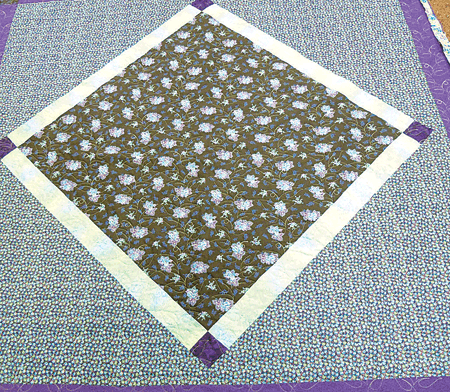 Joan’s diamond-in-a square quilt made from her favorite fabrics brought tears of joy and gratitude to her eyes.