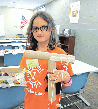 Camp Invention camper Grace O’Connor shows some of the inventions she created.