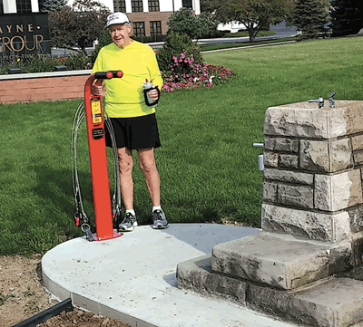 Marathon runner, Bill Harris, takes note of the utility tool pole available for bikers to use located next to the water fountain, along the Tow Path Trail-corner of Engle Road and Jefferson Blvd.